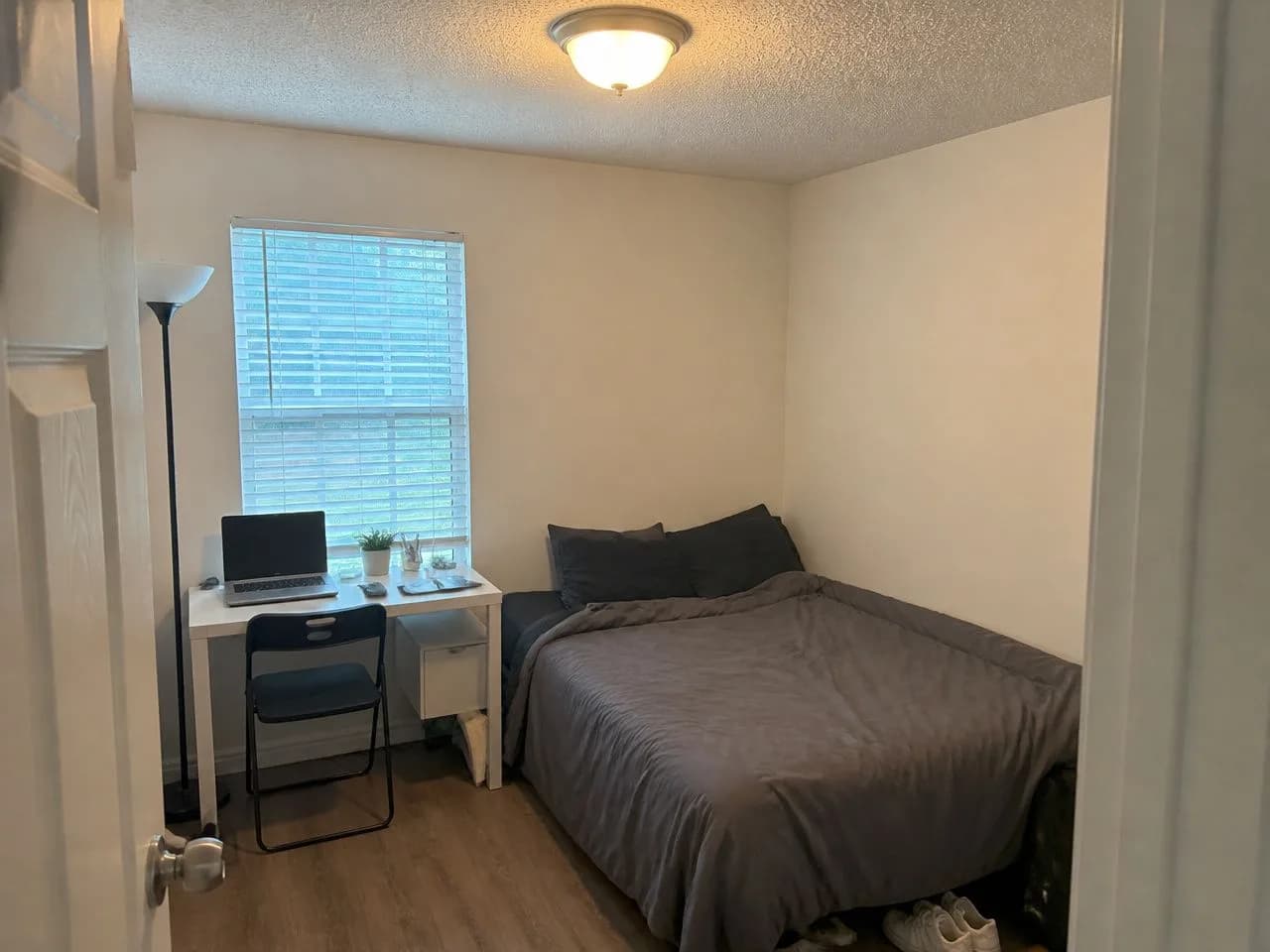 A small bedroom before the AI redesign, an ordinary phone photo