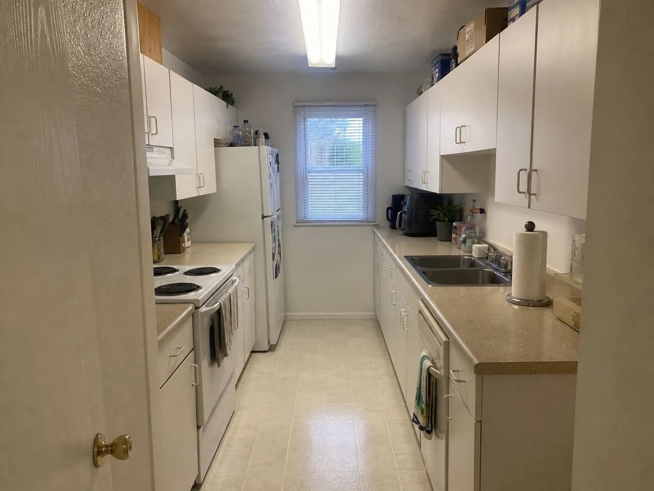 A galley kitchen before the AI redesign, an ordinary phone photo