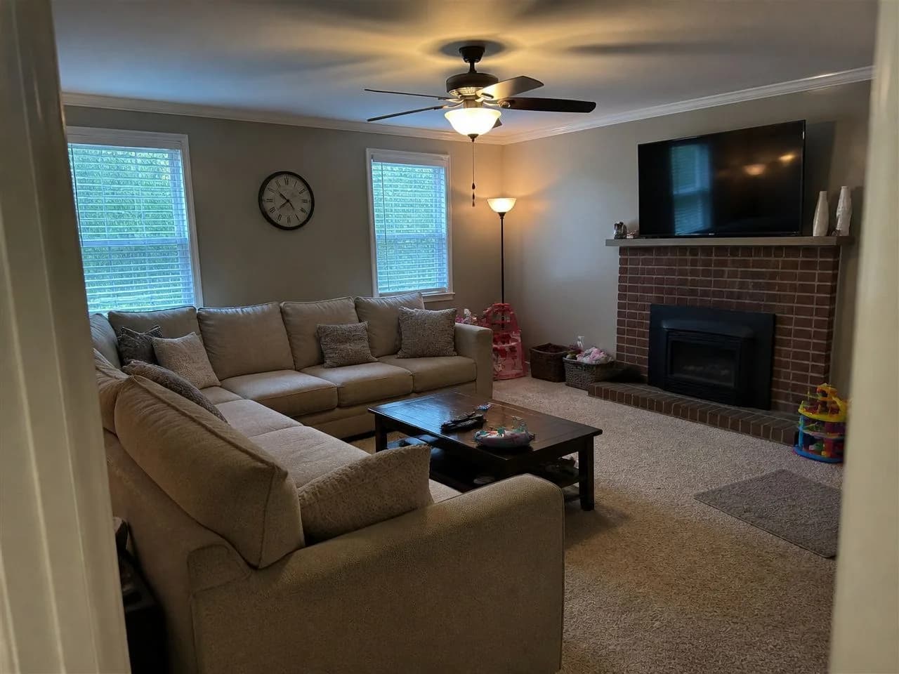 A family living room photographed on a phone from a corner, before the AI redesign